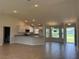 Open concept living room and kitchen with recessed lights and tile flooring at 855 Cumberland Rd, Venice, FL 34293