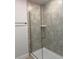Shower stall with glass doors, tile surround, and a built-in shelf at 855 Cumberland Rd, Venice, FL 34293