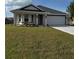 Charming single-story home with a well-manicured lawn, attached garage, and modern design elements, perfect for comfortable living at 664 Linden Rd, Venice, FL 34293