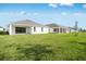 Well-maintained backyard showcasing a newly built home, providing ample space for recreation and outdoor enjoyment at 1580 Laurel Brook Ln, Port Charlotte, FL 33953