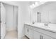 Bathroom with double sinks, white cabinetry, and tile flooring at 1580 Laurel Brook Ln, Port Charlotte, FL 33953