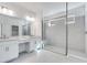Modern bathroom featuring a glass-enclosed shower, dual sinks, and sleek tile flooring at 1580 Laurel Brook Ln, Port Charlotte, FL 33953