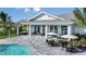 Outdoor community pool area with tables, umbrellas, and comfortable seating, perfect for social gatherings at 1580 Laurel Brook Ln, Port Charlotte, FL 33953