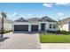 Beautiful single Gathering home featuring a well manicured lawn, a paver driveway, and two-car garage at 1580 Laurel Brook Ln, Port Charlotte, FL 33953