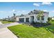 Inviting curb appeal with a paver driveway, manicured lawn, and beautifully designed home with a two-car garage at 1580 Laurel Brook Ln, Port Charlotte, FL 33953