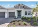 Up close view of the home's front entrance showing a well manicured lawn and a covered entrance at 1580 Laurel Brook Ln, Port Charlotte, FL 33953