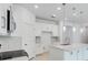 Bright kitchen with a quartz island, stainless appliances, white cabinetry, and modern pendant lights at 1580 Laurel Brook Ln, Port Charlotte, FL 33953