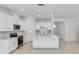 A spacious kitchen with white cabinetry, stainless steel appliances, and a quartz island at 1580 Laurel Brook Ln, Port Charlotte, FL 33953