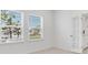 A bright living room with natural light, featuring a glass-paneled door and view of the front yard at 1580 Laurel Brook Ln, Port Charlotte, FL 33953