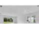 Bright living room featuring a sliding glass door and large windows overlooking the backyard at 1580 Laurel Brook Ln, Port Charlotte, FL 33953