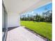 Covered patio with brick flooring, perfect for outdoor relaxation and enjoying the serene backyard view at 1580 Laurel Brook Ln, Port Charlotte, FL 33953