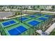 Aerial view of the community's well-maintained pickleball courts, surrounded by landscaping and fencing at 1580 Laurel Brook Ln, Port Charlotte, FL 33953