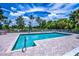 Community pool with lounge chairs and surrounding area at 915 Barclay Ct, Venice, FL 34293