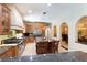 Large kitchen featuring granite island, custom cabinetry, and high-end appliances at 1100 Pine Prairie Rd, Sarasota, FL 34240