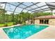 Relaxing pool and spa with screened enclosure and tranquil view at 1100 Pine Prairie Rd, Sarasota, FL 34240