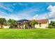 House exterior with terracotta roof and lush landscaping at 1100 Pine Prairie Rd, Sarasota, FL 34240