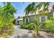 Charming cottage exterior with lush landscaping, a stone path, and idyllic curb appeal at 123 Tidy Island Blvd, Bradenton, FL 34210