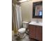 Clean bathroom with wood vanity and striped curtain at 3666 Bonaventure Ct, Sarasota, FL 34243