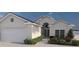Charming single-story home with manicured landscaping, two-car garage and covered entry at 256 Ravenswood Blvd, Port Charlotte, FL 33954