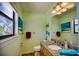 Clean bathroom with granite vanity, toilet and window at 301 S Gulf Blvd # 20, Placida, FL 33946