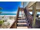 Wooden stairs leading down to a sandy beach at 301 S Gulf Blvd # 20, Placida, FL 33946