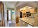 Open concept kitchen with granite counters and island at 301 S Gulf Blvd # 20, Placida, FL 33946