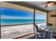 Enclosed porch with ocean views and casual seating at 301 S Gulf Blvd # 20, Placida, FL 33946