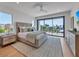 Bright bedroom with plush bedding and access to a private balcony at 809 N Shore Dr, Anna Maria, FL 34216