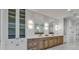 Bathroom with double vanity, large mirrors, and ample storage at 809 N Shore Dr, Anna Maria, FL 34216