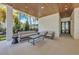 Relaxing patio area with seating and access to backyard at 809 N Shore Dr, Anna Maria, FL 34216