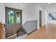 Modern staircase with metal railing and wood floors, leading to upper level at 809 N Shore Dr, Anna Maria, FL 34216