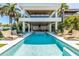 Modern pool with a spacious deck and lounge chairs at 809 N Shore Dr, Anna Maria, FL 34216