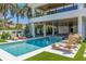 Inviting swimming pool with spacious deck and lounge chairs at 809 N Shore Dr, Anna Maria, FL 34216
