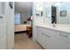 Bathroom with double vanity and view into bedroom at 3780 Pinebrook Cir # 504, Bradenton, FL 34209