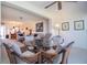 Cozy dining area with wicker chairs and glass-top table, open to living room at 3780 Pinebrook Cir # 504, Bradenton, FL 34209