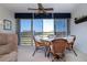 Bright dining area features glass top table and wicker chairs with scenic view at 3780 Pinebrook Cir # 504, Bradenton, FL 34209