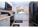 Modern kitchen featuring white cabinets, black appliances, and ample counter space at 3780 Pinebrook Cir # 504, Bradenton, FL 34209