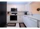Well-equipped kitchen with modern appliances and white cabinetry at 3780 Pinebrook Cir # 504, Bradenton, FL 34209