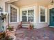 Relaxing front porch with a brick patio and potted plants at 1703 Starling Dr # 1703, Sarasota, FL 34231