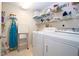 Laundry room with washer, dryer, and shelving for storage at 3780 Pinebrook Cir # 504, Bradenton, FL 34209