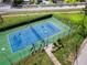 Well-maintained tennis and pickleball court with surrounding green space at 3780 Pinebrook Cir # 504, Bradenton, FL 34209