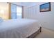 Bright bedroom with a double bed, window with blinds, and spacious closet at 3780 Pinebrook Cir # 504, Bradenton, FL 34209