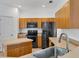 Modern kitchen with black appliances and wood cabinets at 3523 Sapelo Ave, North Port, FL 34286
