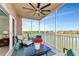 Relaxing screened balcony with ceiling fan, seating and beautiful lake view at 10520 Boardwalk Loop # 401, Lakewood Ranch, FL 34202