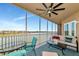 Spacious balcony with seating for lounging, ceiling fan and beautiful lake view at 10520 Boardwalk Loop # 401, Lakewood Ranch, FL 34202
