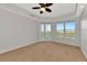 Empty bedroom features a balcony with a lake view at 10520 Boardwalk Loop # 401, Lakewood Ranch, FL 34202