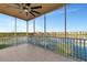 Enjoy lake views from this screened patio with tile floor and ceiling fan at 10520 Boardwalk Loop # 401, Lakewood Ranch, FL 34202