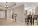 Bright foyer with tile floors and view into kitchen at 6430 Watercrest Way # 201, Lakewood Ranch, FL 34202