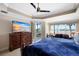 Main bedroom with large TV, water views, and access to balcony at 6430 Watercrest Way # 201, Lakewood Ranch, FL 34202