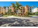 Luxury condo building with palm trees and ample parking at 6430 Watercrest Way # 201, Lakewood Ranch, FL 34202